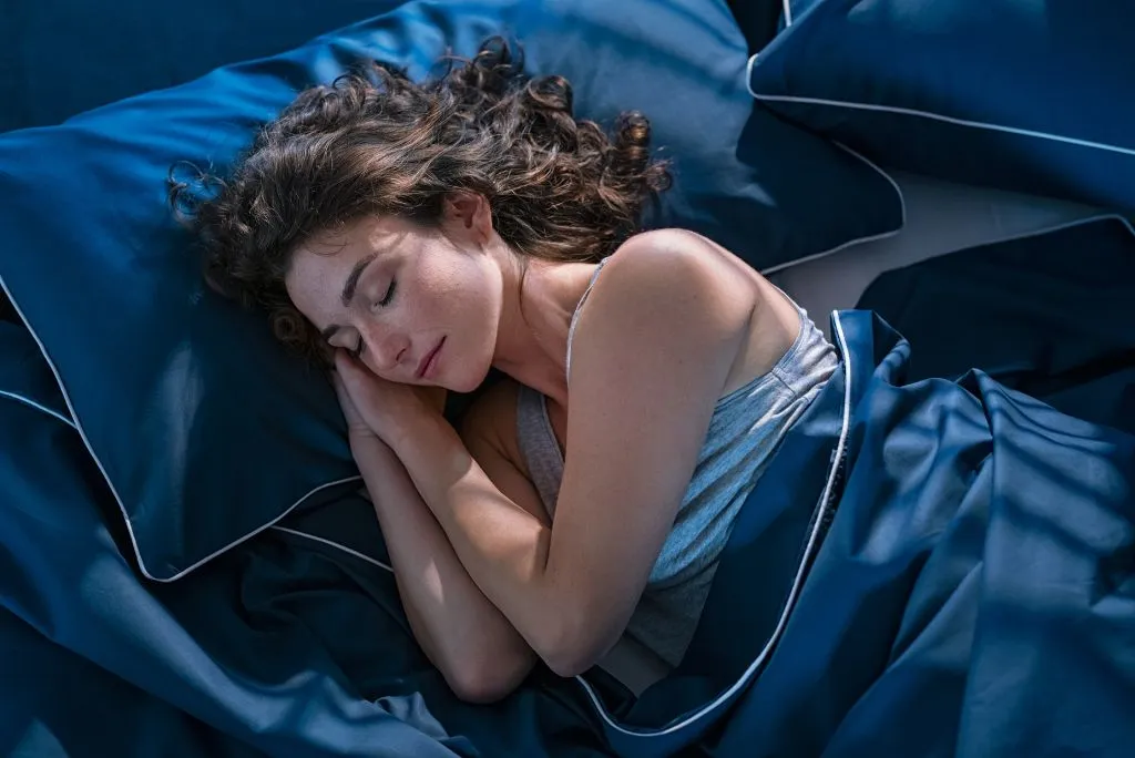 woman sleeping in luxury bedding